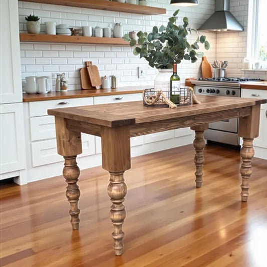 Handcrafted solid wood kitchen island in farmhouse kitchen with turned legs and thick wood top built  in Texas